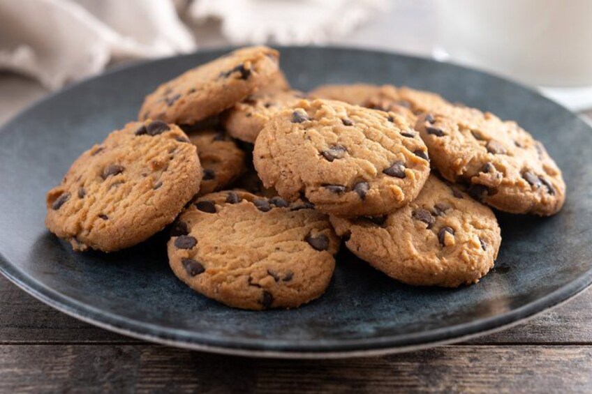 A plate of chocolate chip cookies on a dark plate. 2