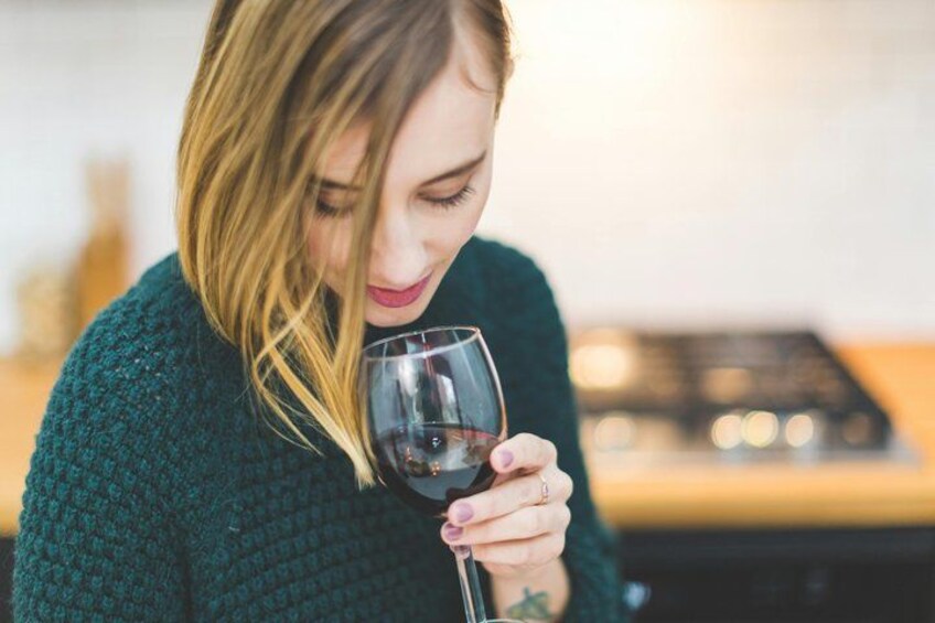 A person holding a wine glass. 2