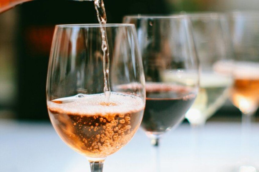 A glass of wine being poured. 1