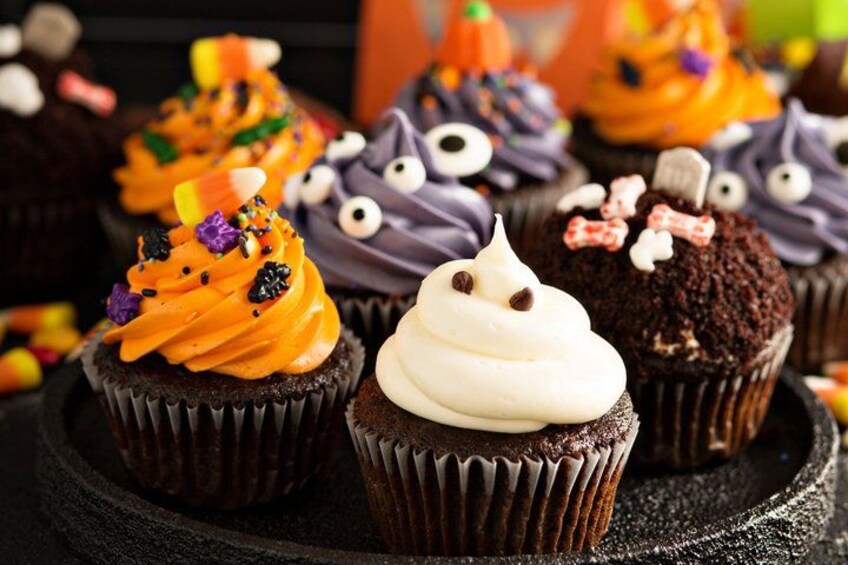 A variety of cupcakes with different frosting colors and decorations. 4