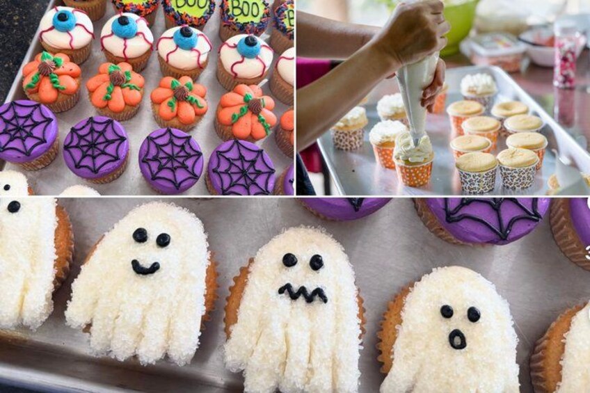 A variety of decorated cupcakes, including some with spooky themes like ghosts and spiders. 1
