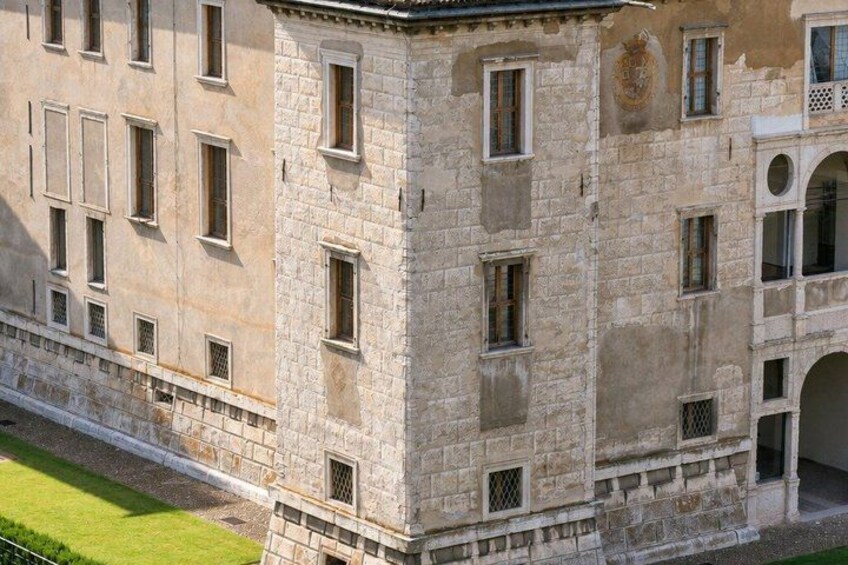 A stone building with multiple windows and a well-maintained lawn. 5