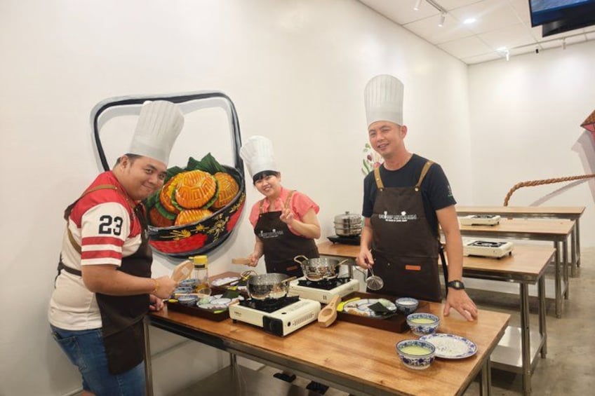 A group of chefs preparing food in a kitchen. 2