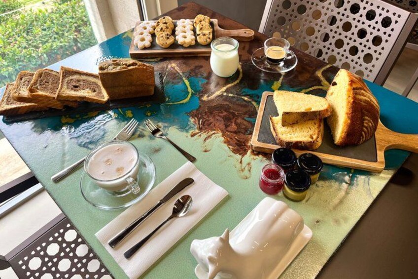A breakfast table with toast, jam, butter, and a cup of coffee. 3