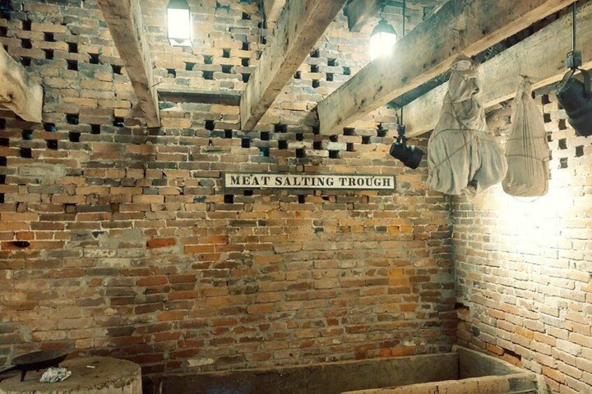 A brick wall with a sign reading 'MEAT SALTING TROUGH.' 3