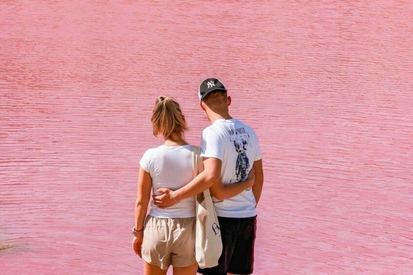 Two people standing on a pink-painted surface. 4