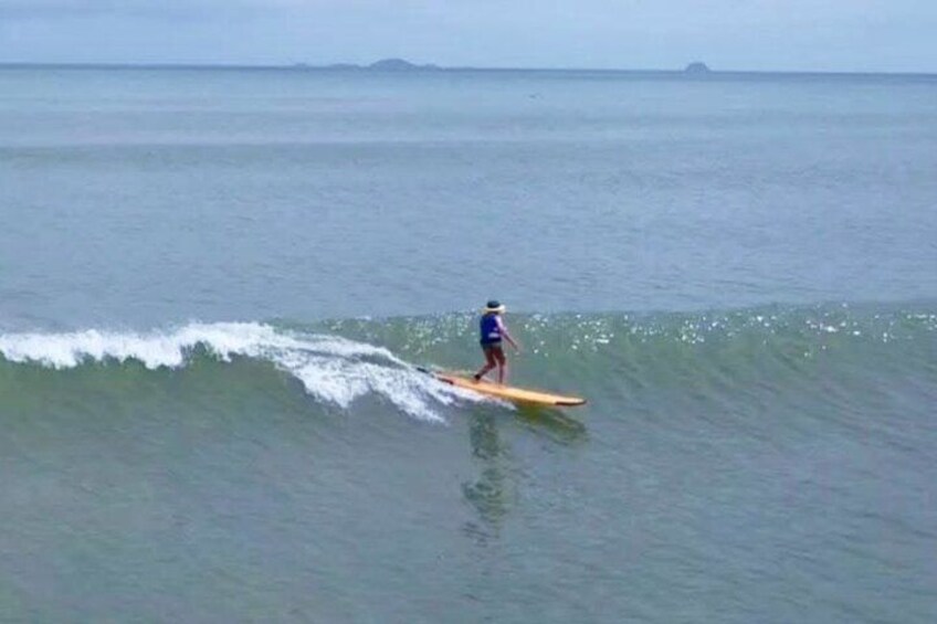 A person surfing on a wave in the ocean. 2