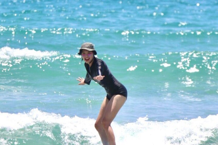 A person surfing on a wave in the ocean. 4