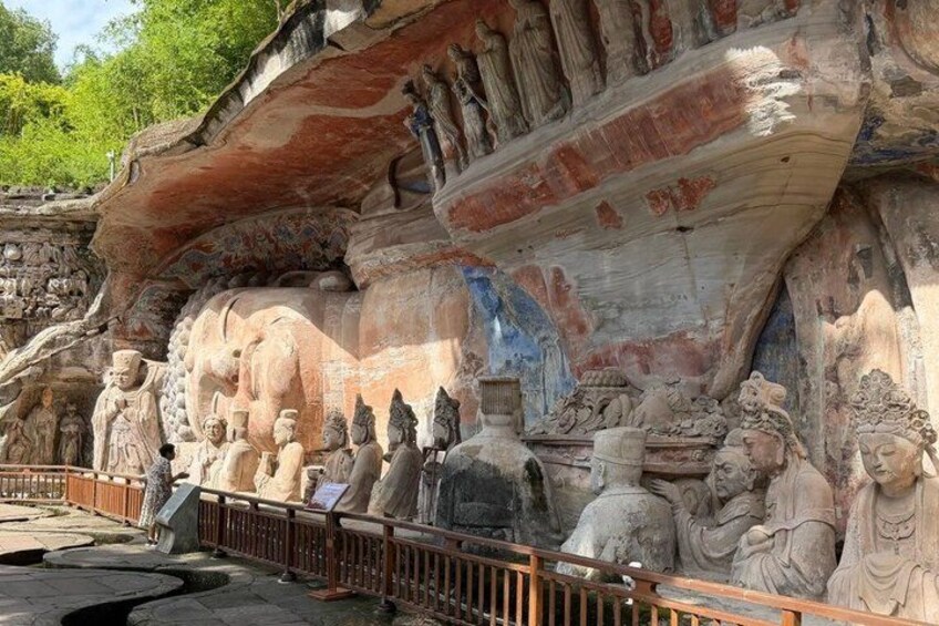 A rock face with ancient carvings of figures and animals. 4