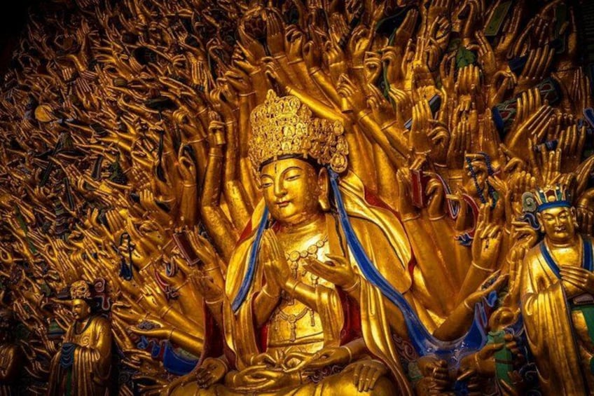 A golden statue surrounded by numerous smaller golden figures. 1