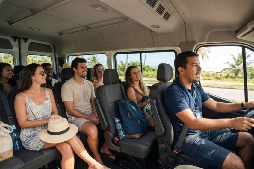 A vehicle interior with passengers seated. 2
