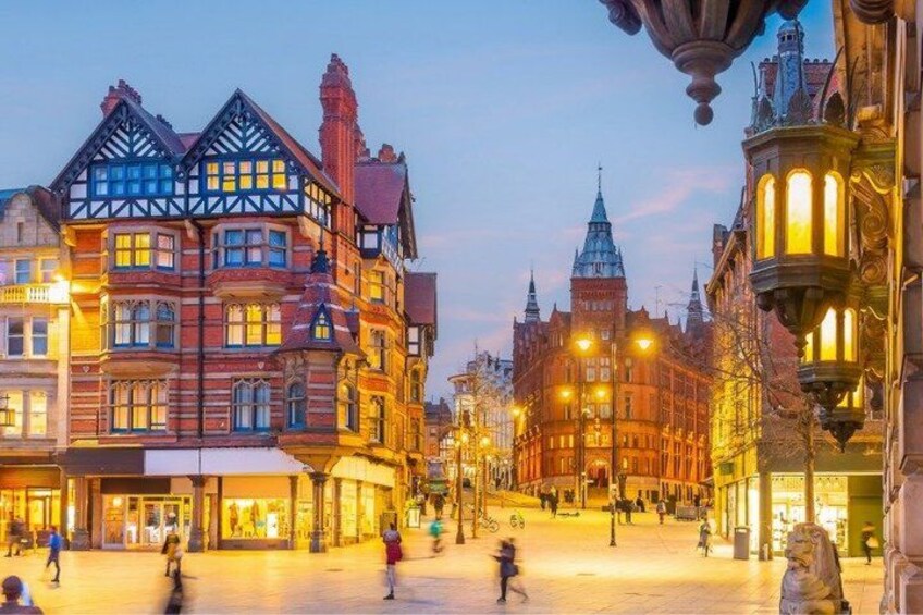 A historic European town square with traditional architecture, including half-timbered buildings and ornate street lamps. 5