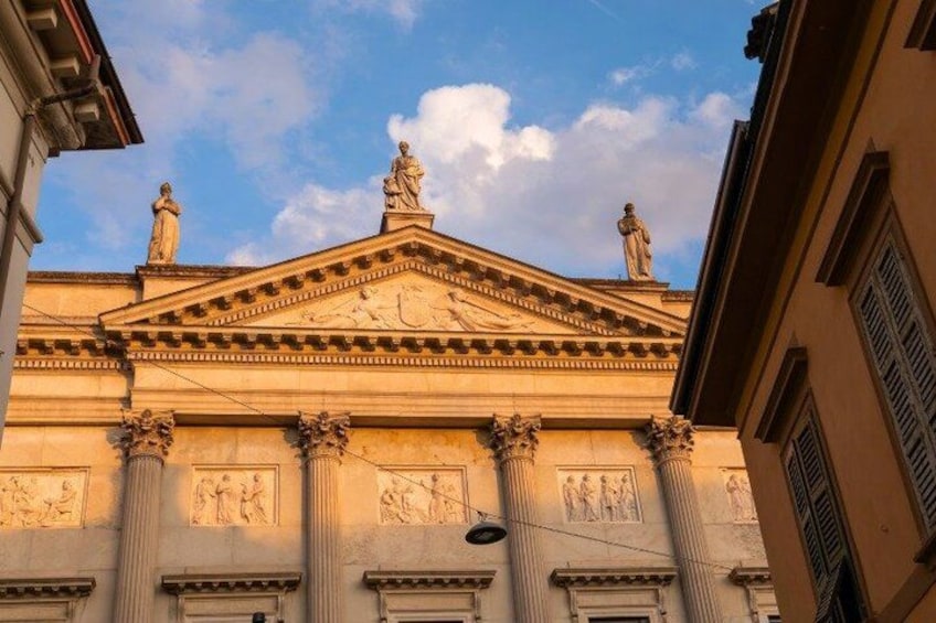 A classical building with columns and statues. 5