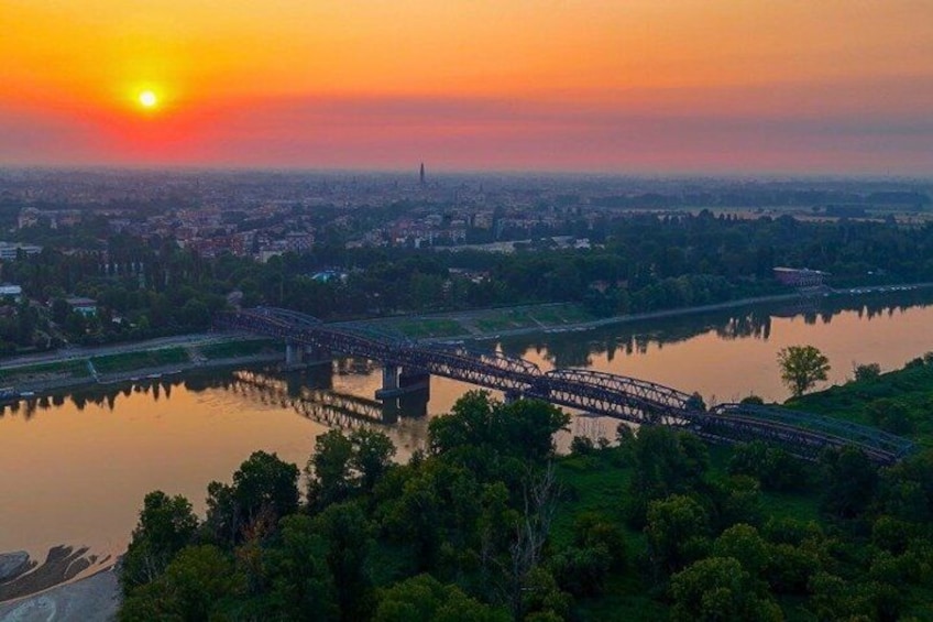 A sunset over a city with a bridge spanning a river. 4
