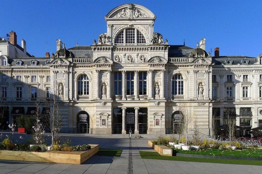 A grand classical building with a central entrance, large windows, and statues. 4