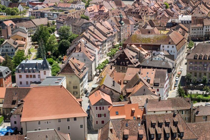 A densely packed urban area with historic buildings, narrow streets, and a mix of residential and commercial architecture. 2