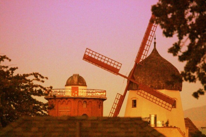 A windmill with a dome and a traditional windmill structure. 1