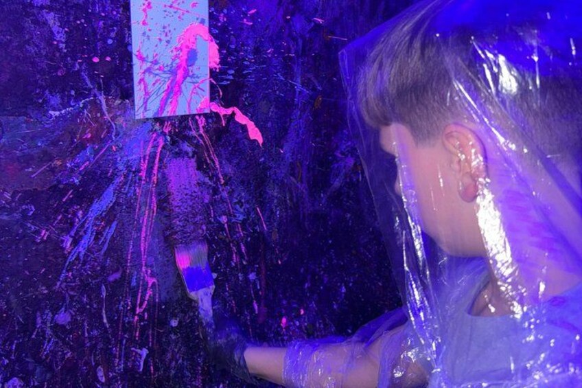 A person painting on a wall with a protective mask and plastic wrap. 5
