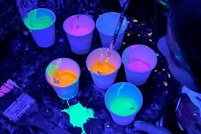 Several cups with colorful liquid, possibly for a party or event. 1