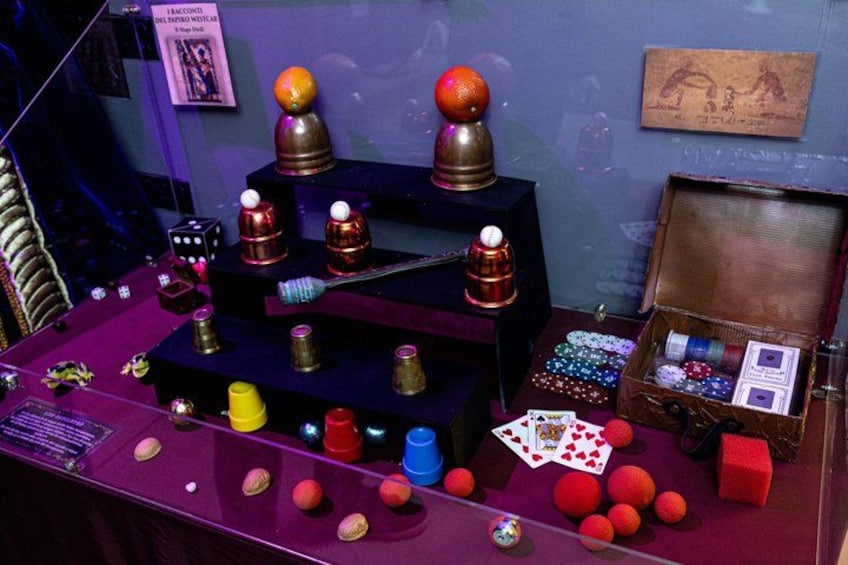 A display of various objects including balls, bottles, and playing cards. 5