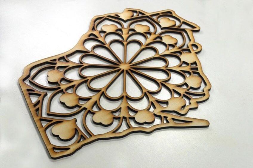 A decorative wooden cutout with intricate floral patterns. 4