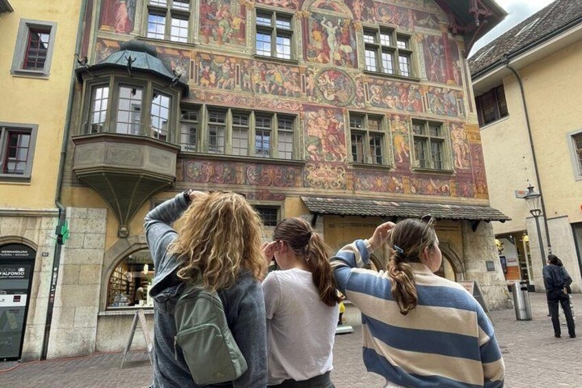 A building with a colorful facade and a small tower. 3