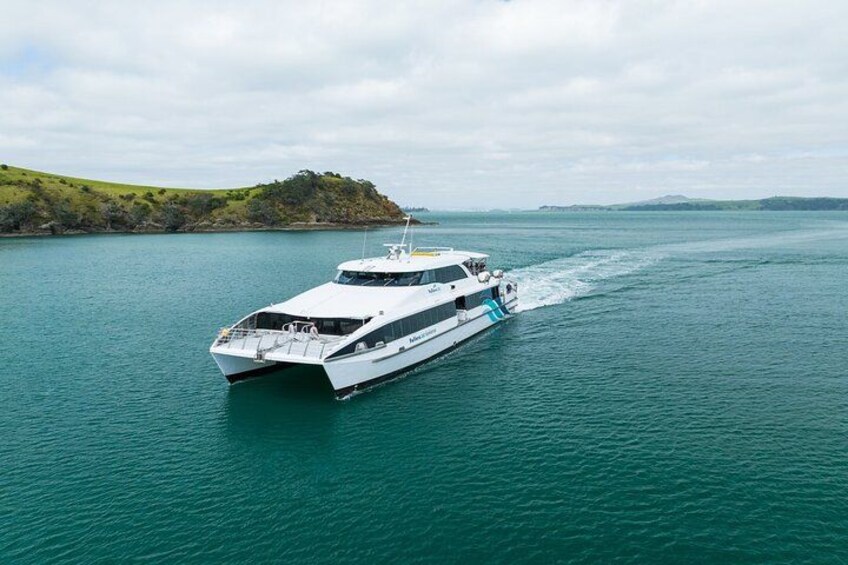 A white yacht on a calm body of water with a hilly landscape in the background. 5
