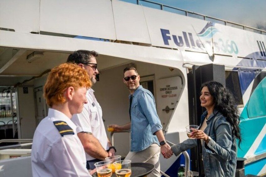 A group of people on a boat with a sign that reads 'Crew Access Only Keep Clear.' 1