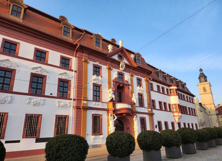 A historic building with ornate architecture, including statues and decorative elements. 5