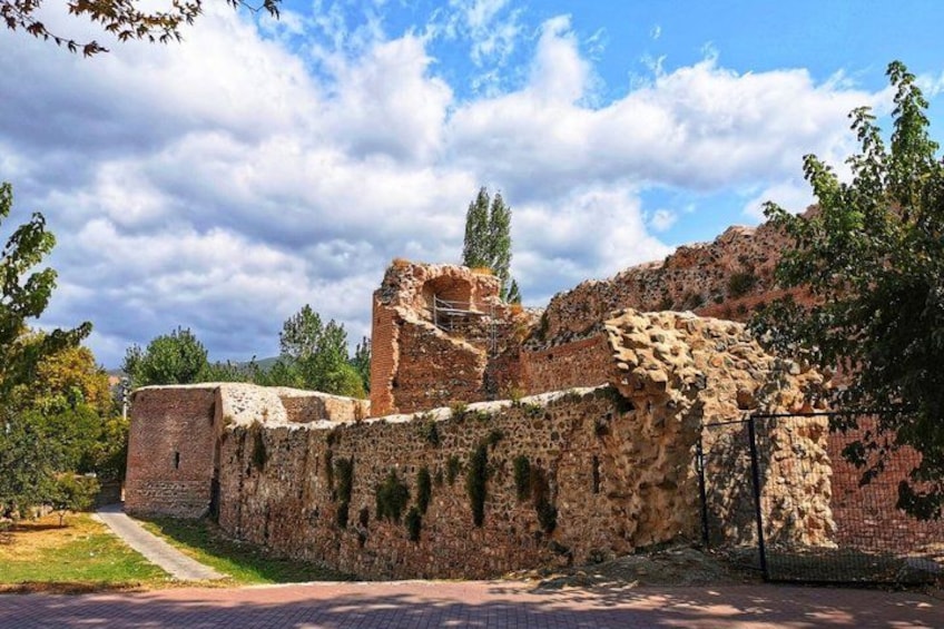 Ancient ruins with stone walls and a partially intact structure. 5