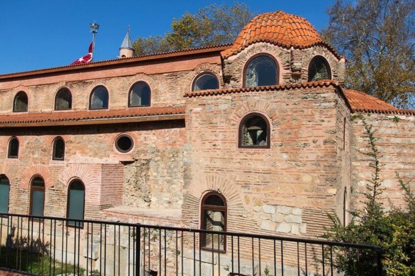 A historic building with arched windows and a tiled roof. 3