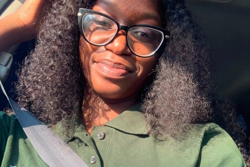 A person with curly hair wearing a green shirt. 2