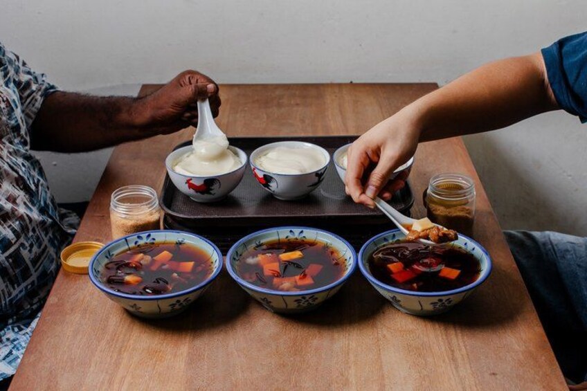 A person serving soup from a bowl. 3
