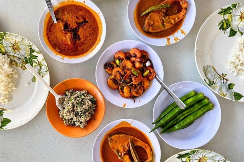 A variety of dishes including curry, rice, and a bowl of what appears to be a vegetable dish. 1