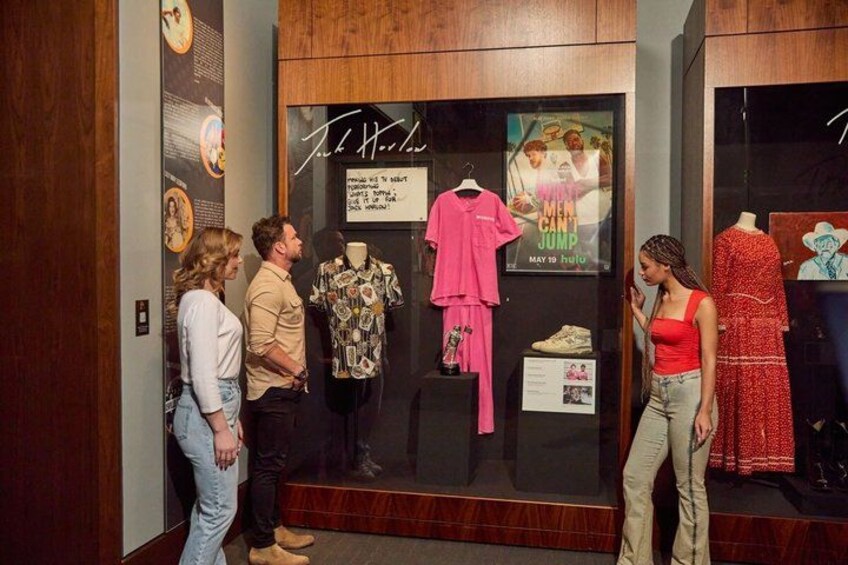 A clothing store with mannequins displaying outfits. 4
