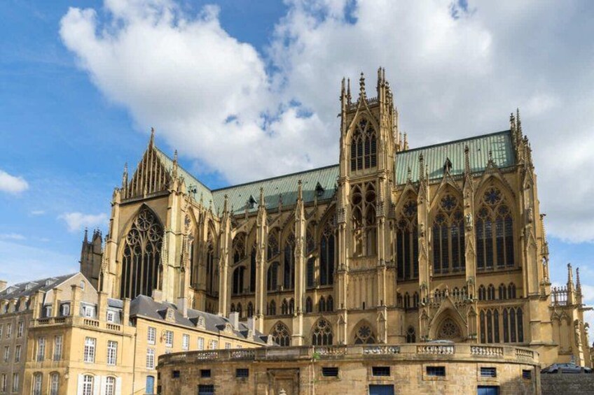 A large Gothic cathedral with intricate architecture and a prominent clock tower. 2