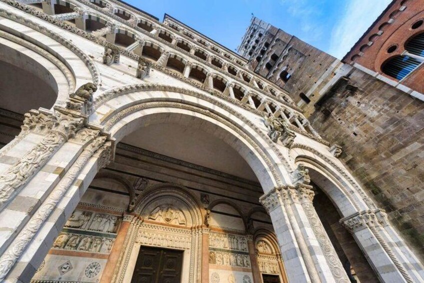 An ornate stone archway with intricate carvings and a large wooden door. 4