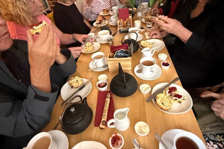 A group of people sitting around a table with food and drinks. 3
