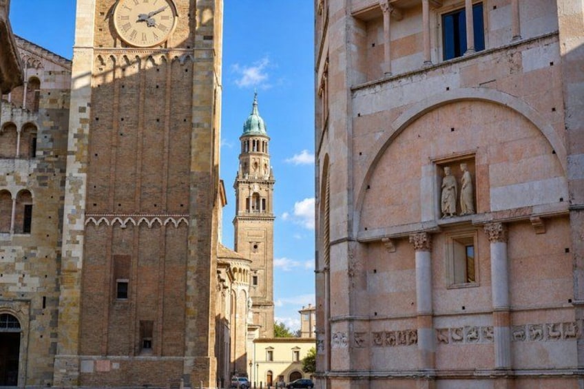 A historic building with a clock tower and arched windows. 3