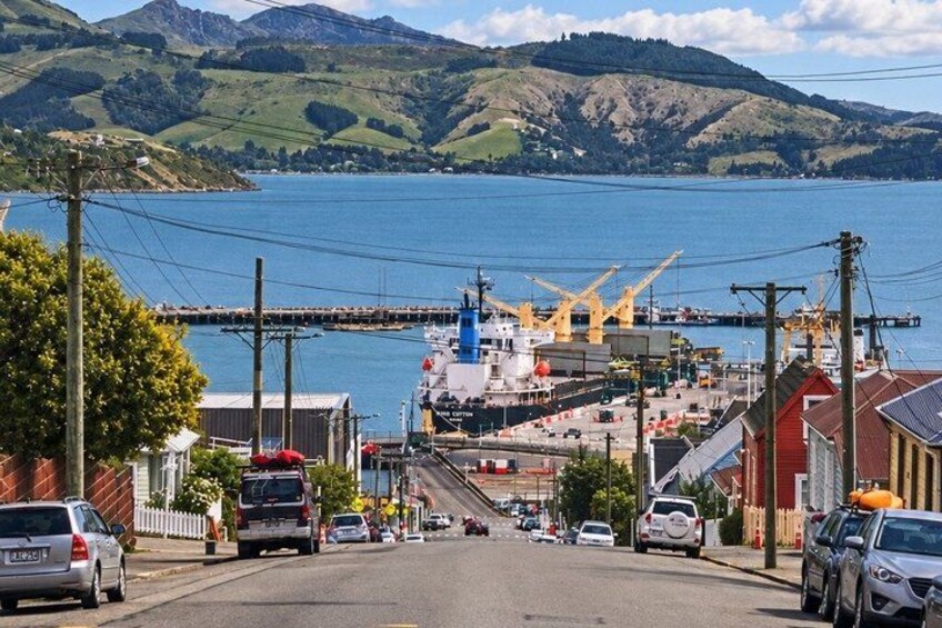 A coastal town with a harbor, boats, and a bridge. 4