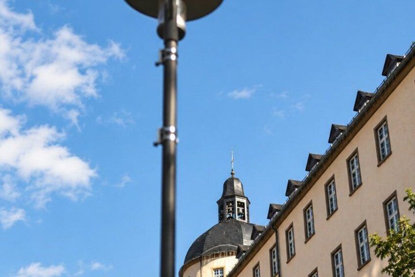 A building with a dome and a spire against a clear blue sky. 5
