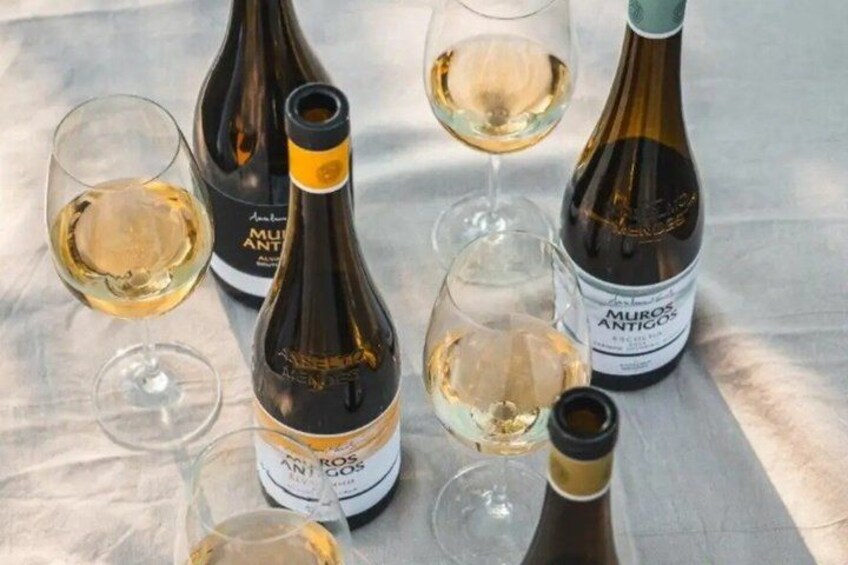 Wine bottles and glasses on a table. 4