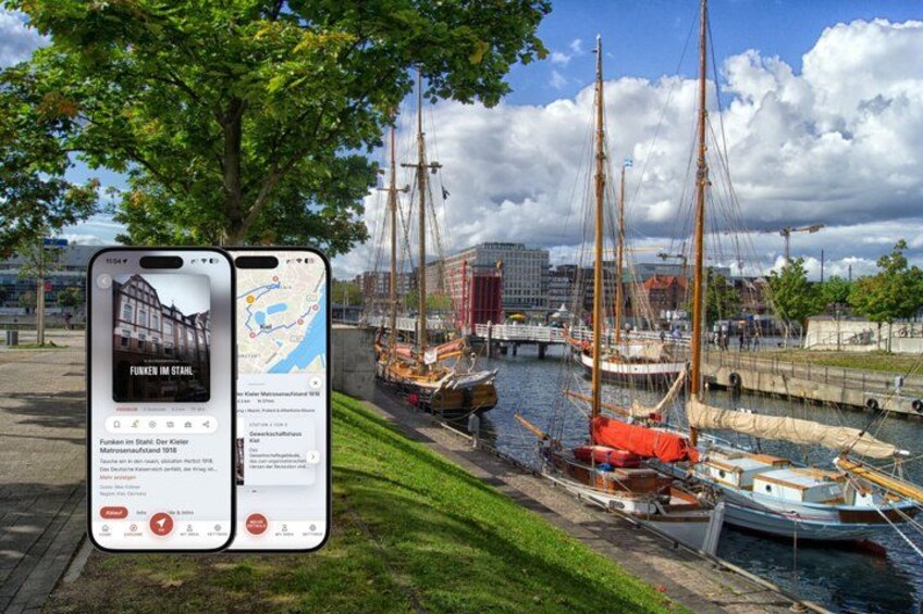 A smartphone displaying a map with a marina and sailboats. 1