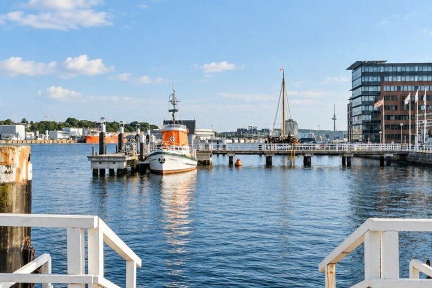 A harbor with boats, a bridge, and buildings. 4
