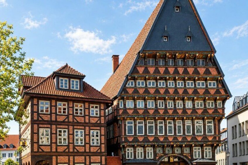 A traditional half-timbered house with a steeply pitched roof and a prominent tower. 3
