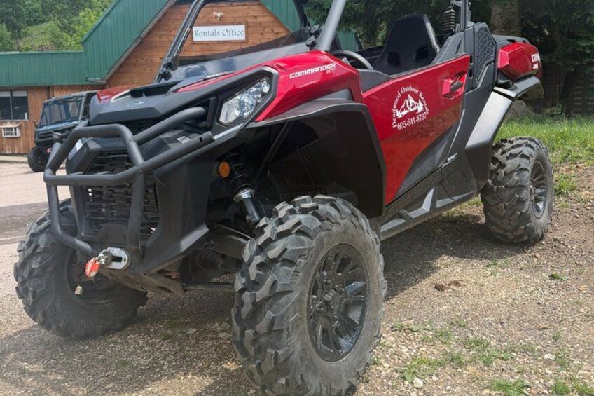 A red ATV parked in front of a building labeled 'Rentals Office.' 3