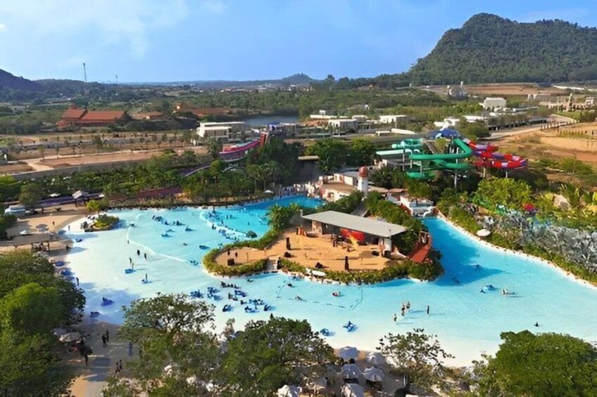 A water park with a large pool, water slides, and a beach area. 2