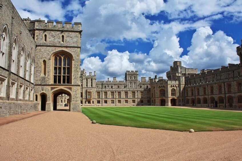 A historic building with a large lawn in front. 4