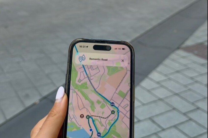 A smartphone displaying a map with a route marked by a blue line, indicating a path or journey. 2