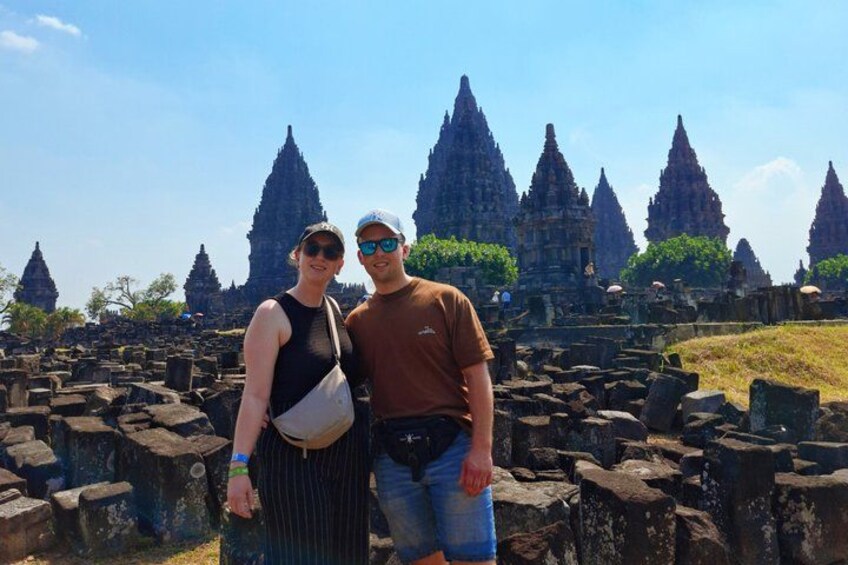 Two people standing in front of ancient stone structures. 3